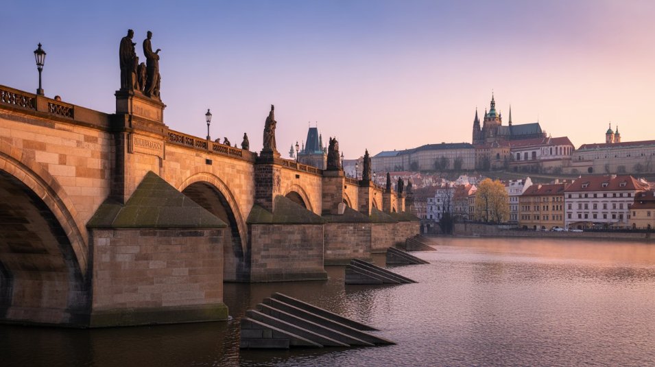 Charles Bridge at sunrise — Prague’s fairytale charm comes alive with Gothic spires and medieval streets.